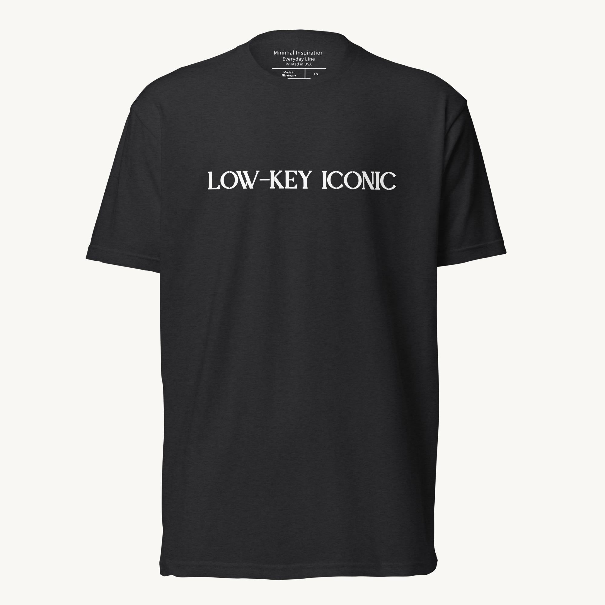 Black unisex fitted T‑shirt with minimalist ‘Low Key Iconic’ design.