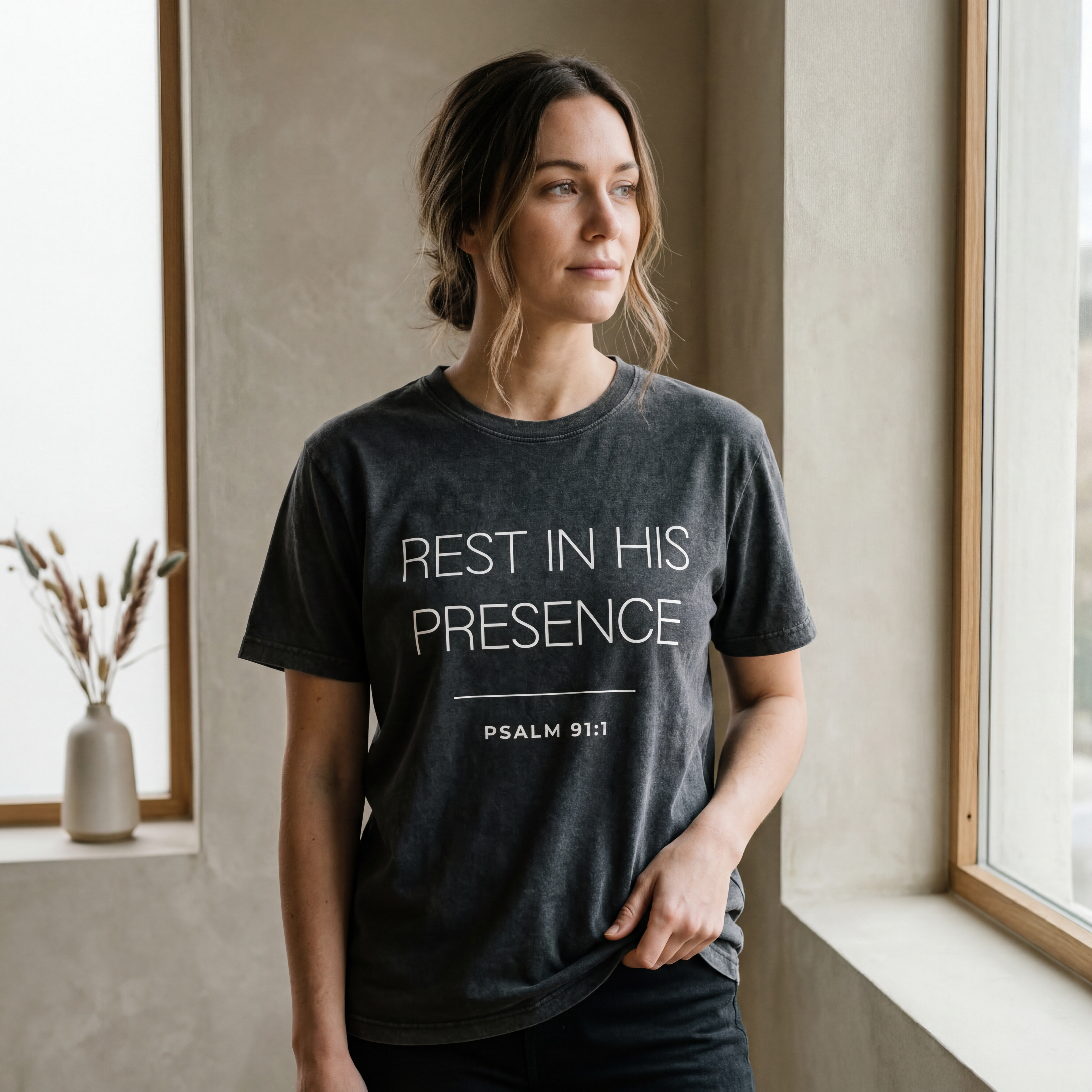 Woman wearing the "rest in his presence psalm 91:1" motivational t shirt in warm natural sunlight with a peaceful, reflective mood.