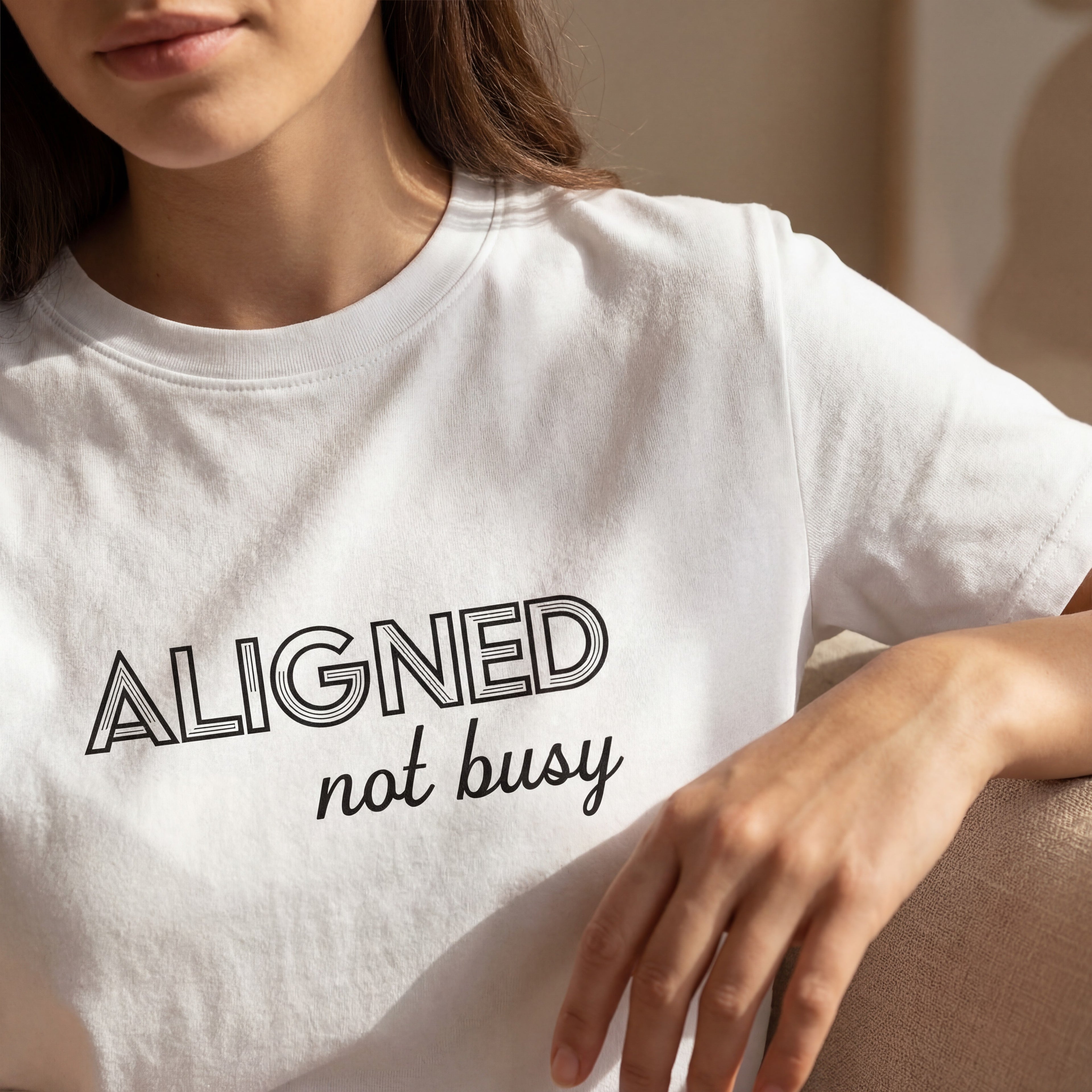 Close up of the "aligned not busy" organic cotton t shirt showing soft fabric texture and clean printed text.