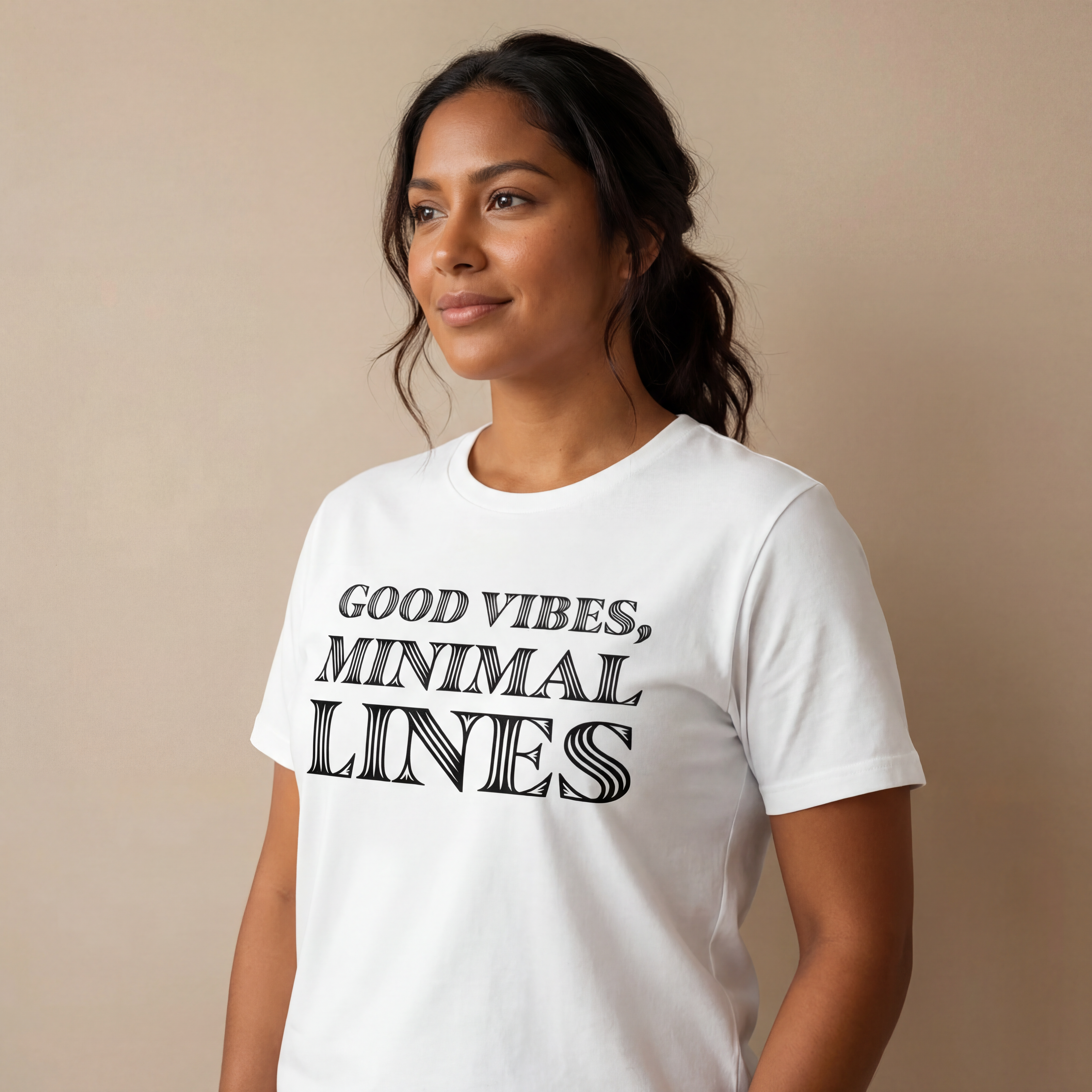 Side angle studio view of a woman wearing the "good vibes, minimal lines" minimalist graphic tee with a calm, natural expression.