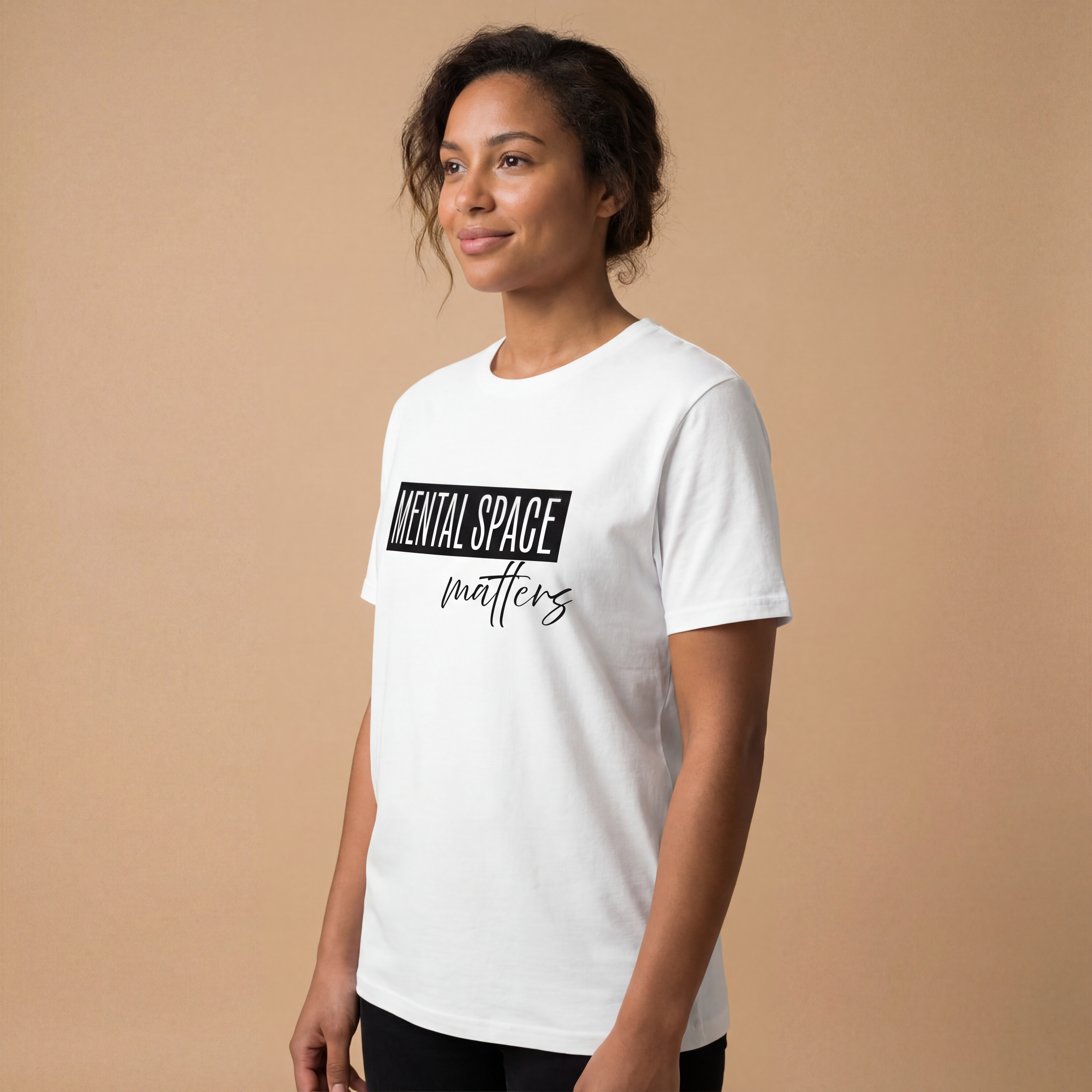 Side angle studio view of a woman wearing the "mental space matters" minimalist graphic tee with a calm, natural expression.