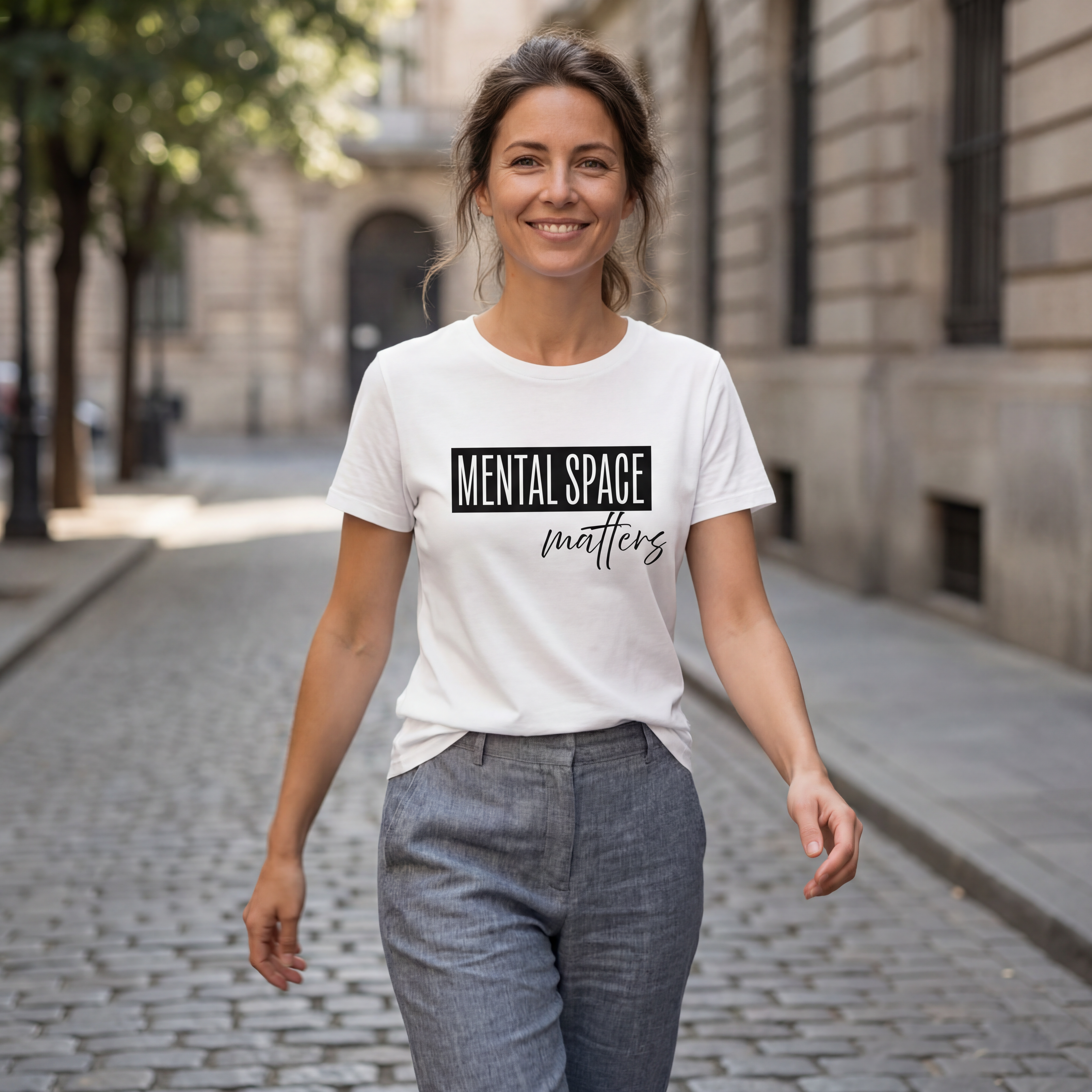 Woman wearing the "mental space matters" minimalist graphic tee with gentle movement and a warm, approachable expression.