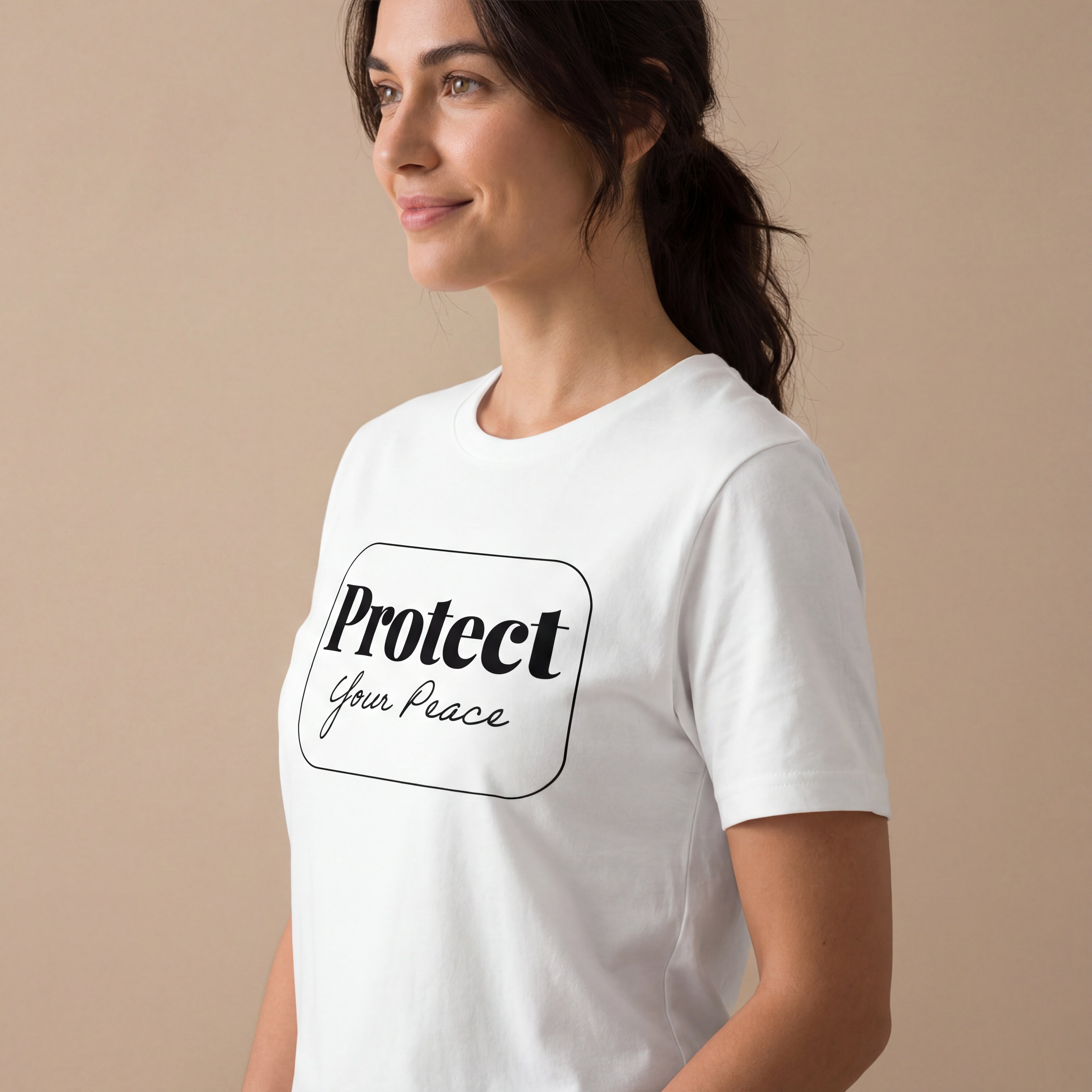 Side angle studio view of a woman wearing the Protect your peace minimalist graphic tee with a calm, natural expression.