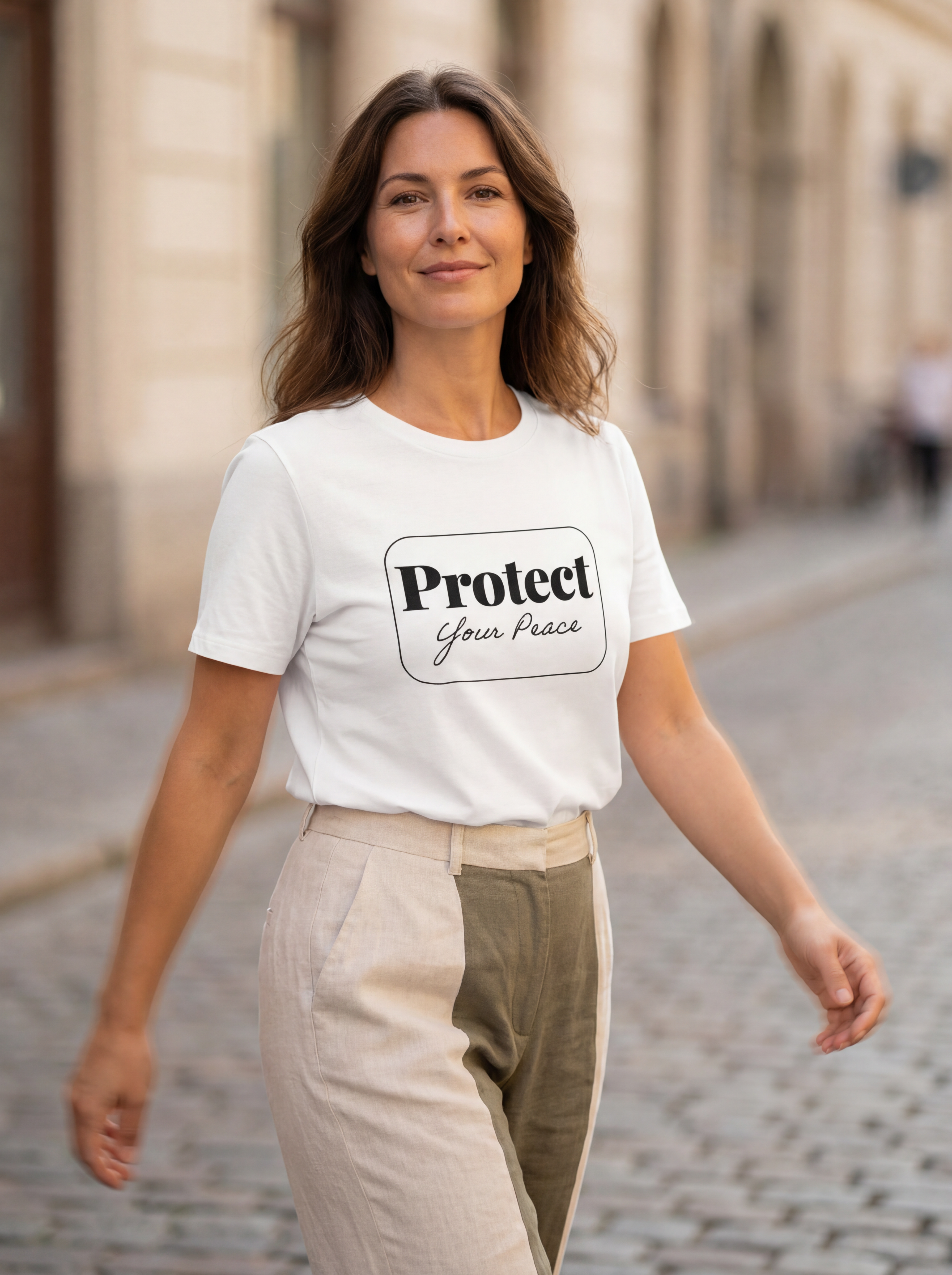 Woman wearing the Protect your peace minimalist graphic tee with gentle movement and a warm, approachable expression.